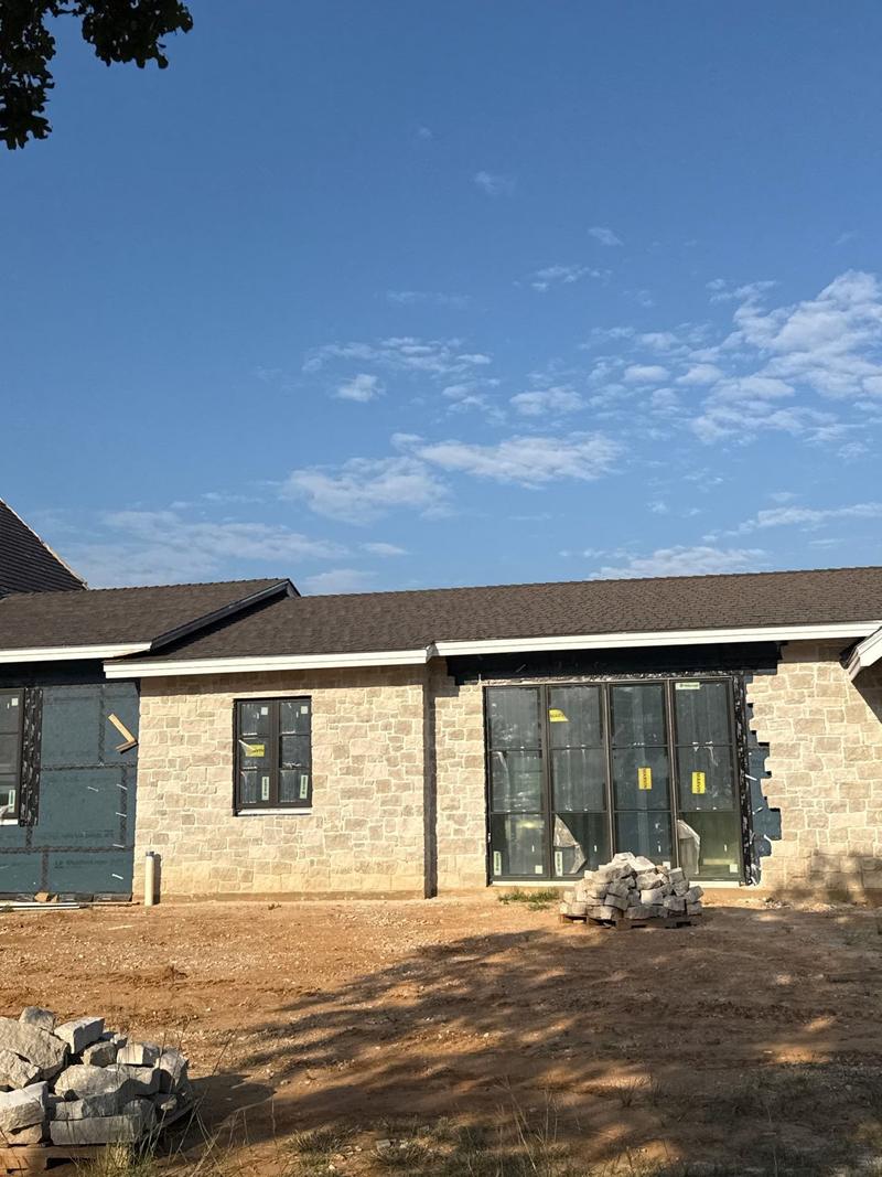 Synthetic shake roof on a new stone ranch home near Bowie, TX
