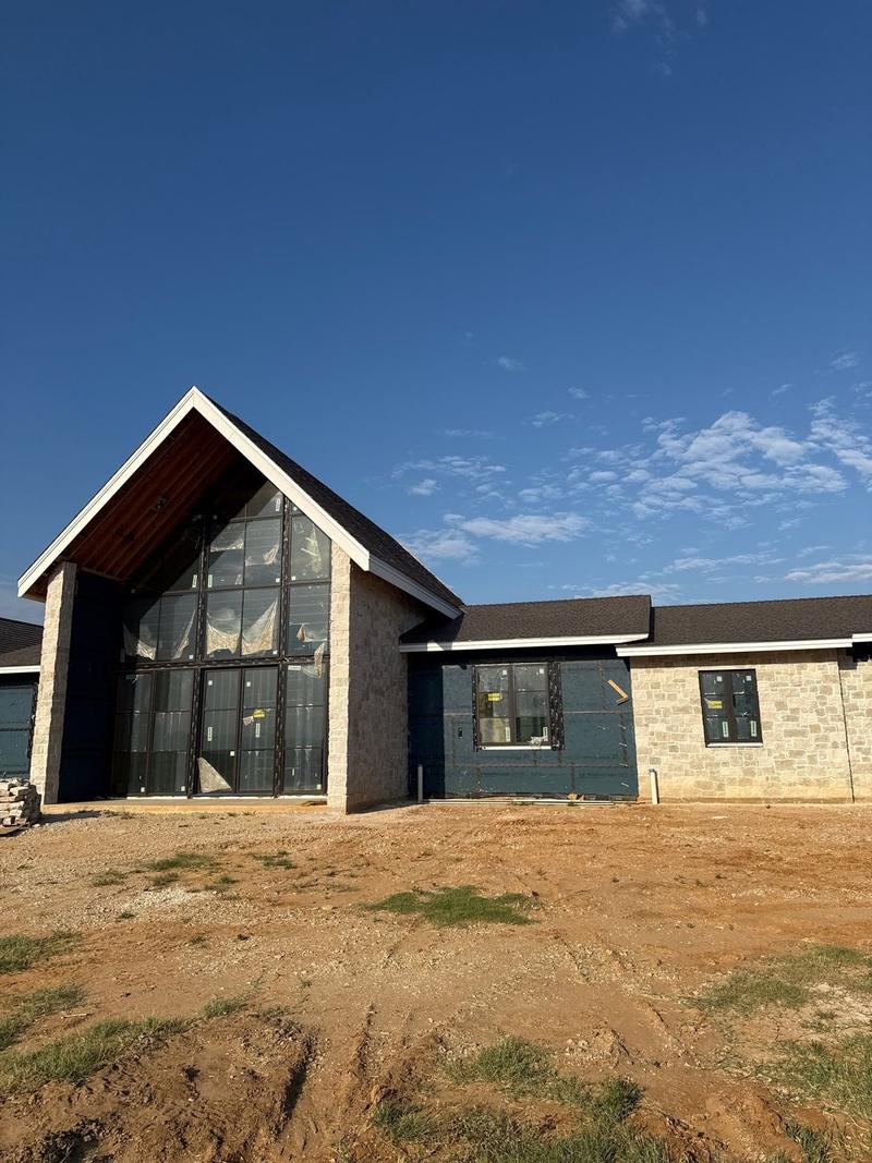 Enviroshake synthetic shake roof over a stone and board-and-batten home in North Texas