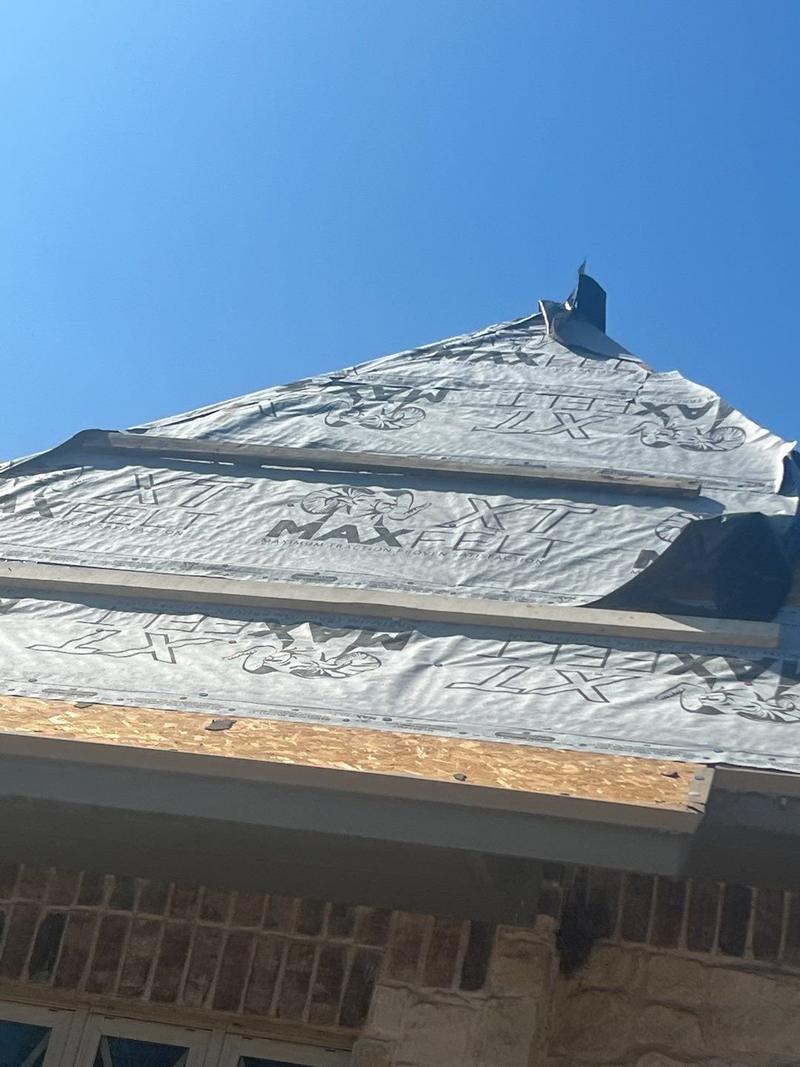 Synthetic underlayment on a steep hip roof before slate-look shingles were installed