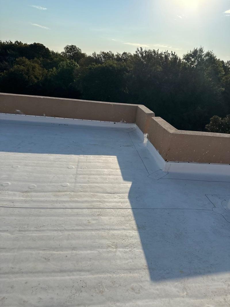 New white TPO membrane roof with parapet walls on a home near Decatur, TX